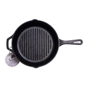 Black cast iron skillet with a handle on a white background