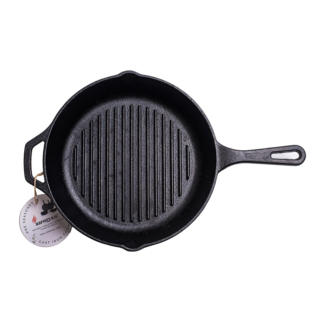 Black cast iron skillet with a handle on a white background