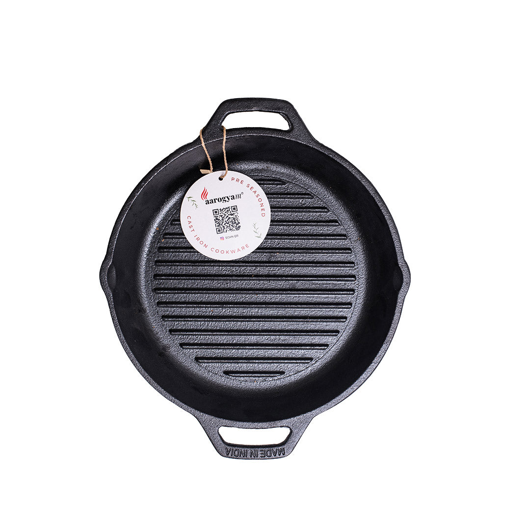 Black cast iron skillet with a brand tag on a white background