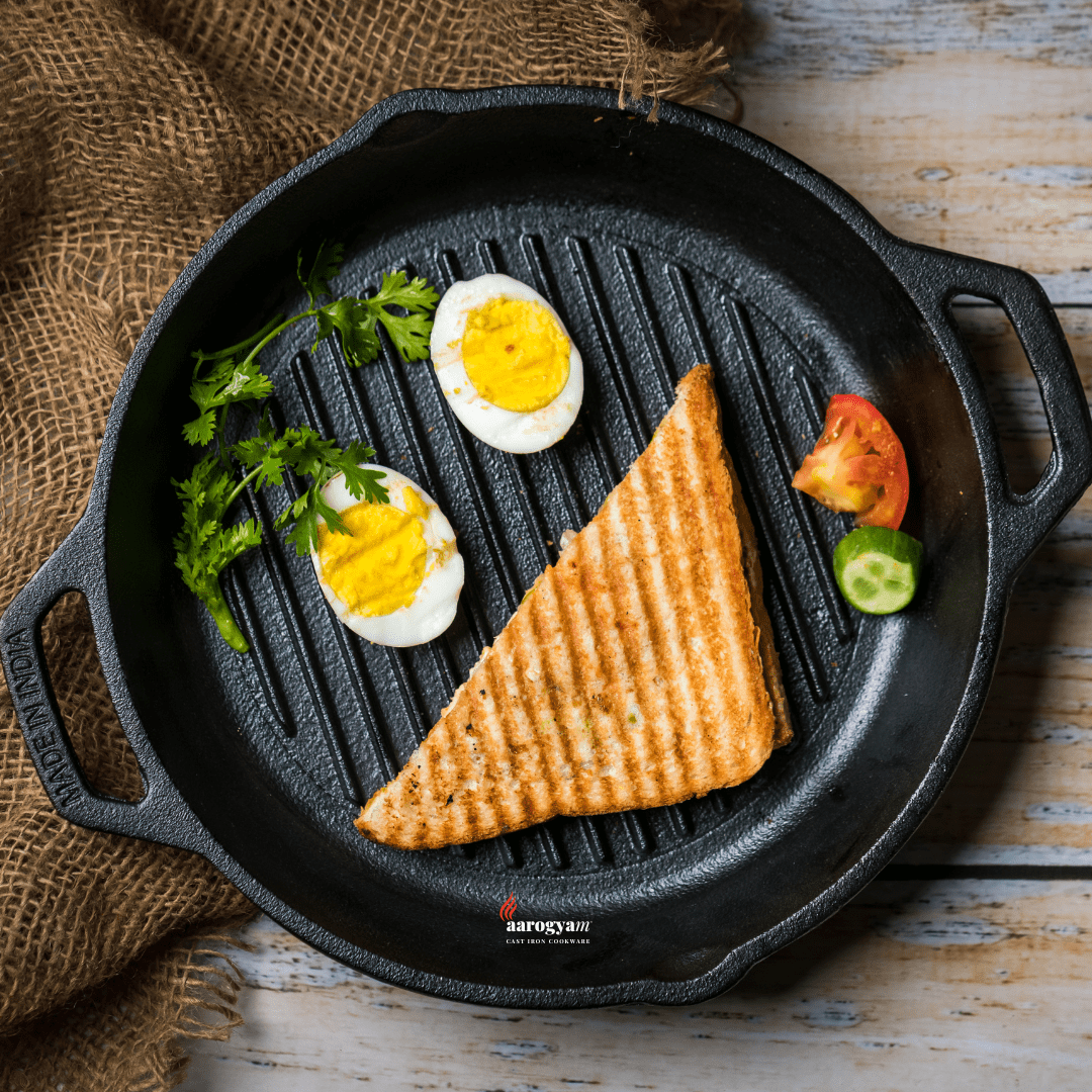 Grilled sandwich with eggs and vegetables on a cast iron skillet