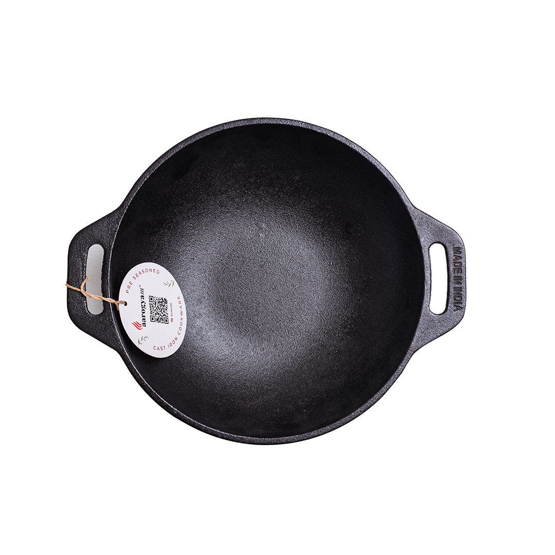 Black cast iron skillet with a brand label on a white background
