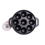 Black cast iron pan with round compartments on a white background