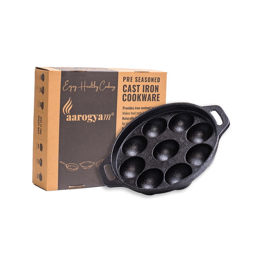 Cast iron cookware with aarogyan packaging on a white background