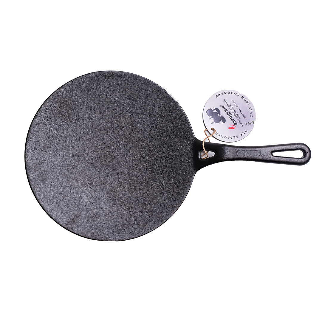 Black cast iron skillet with a handle on a white background
