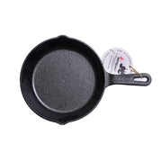 Black cast iron skillet with a handle on a white background