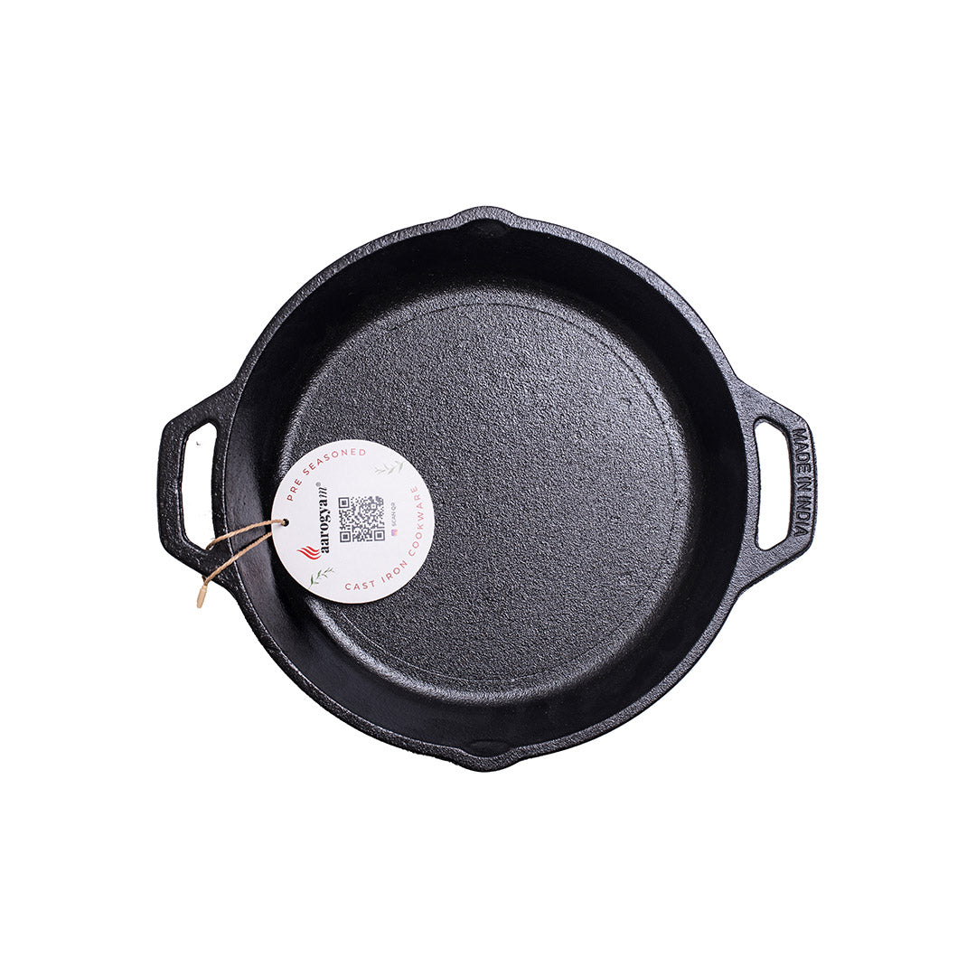Black cast iron skillet with a white label on a white background