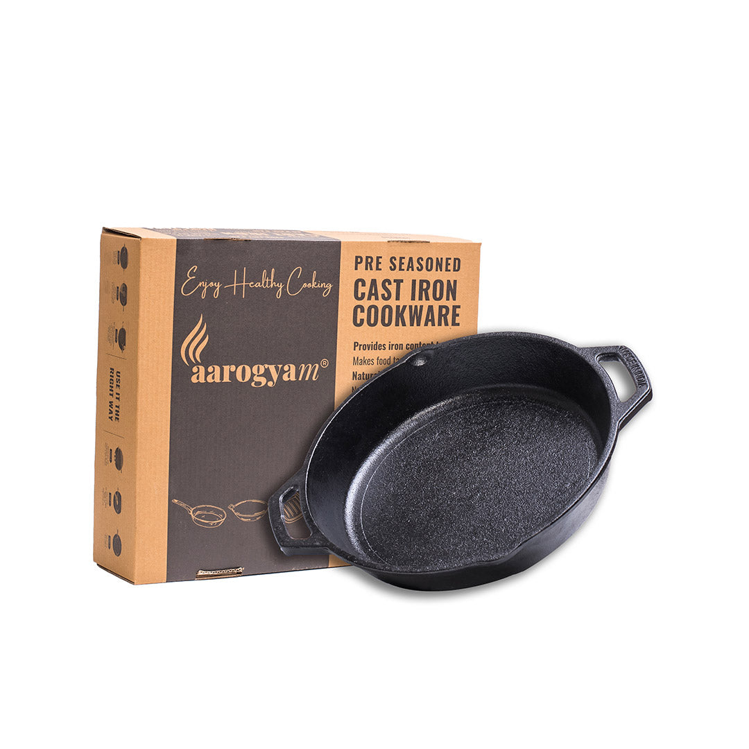 Cast iron skillet with aarogyam packaging on a white background