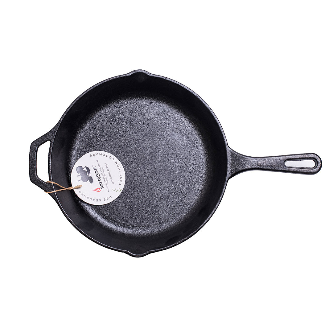 Black cast iron skillet with a brand label on a white background