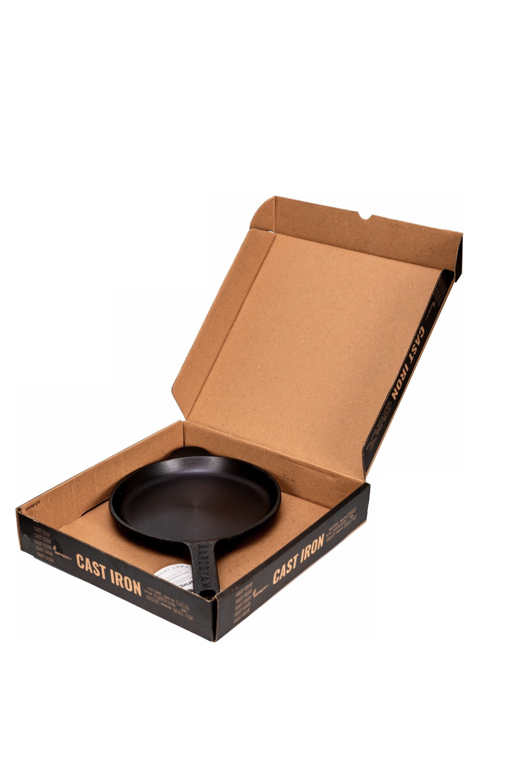 Cast iron skillet in a cardboard box on a white background