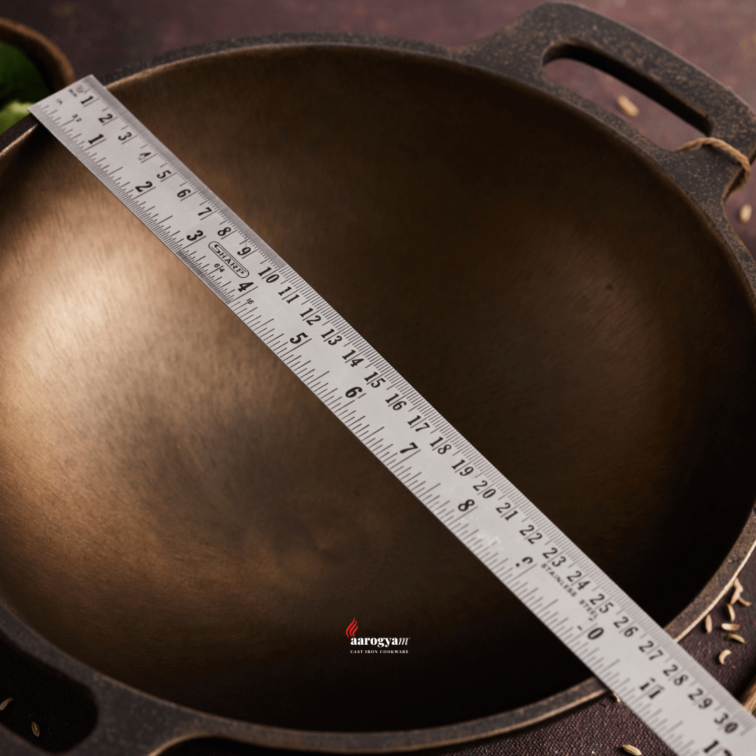 Cast iron skillet with a ruler for measurement on a dark background