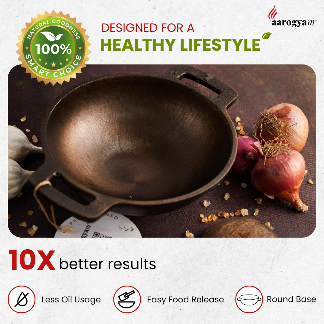 Cast iron wok with onions and garlic, labeled 'Aarogya' for a healthy lifestyle.