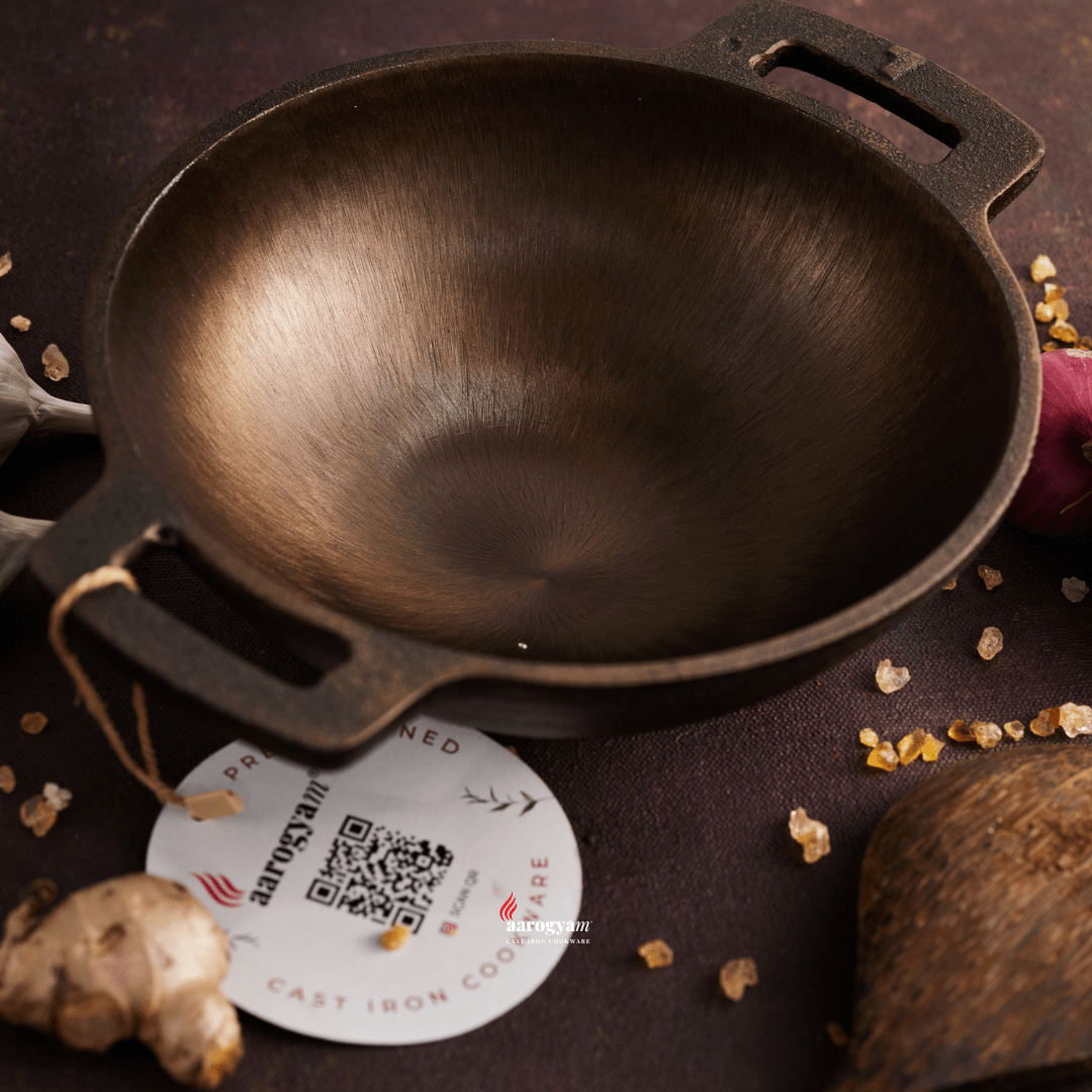 Cast iron skillet on a dark surface with a brand tag featuring a QR code.