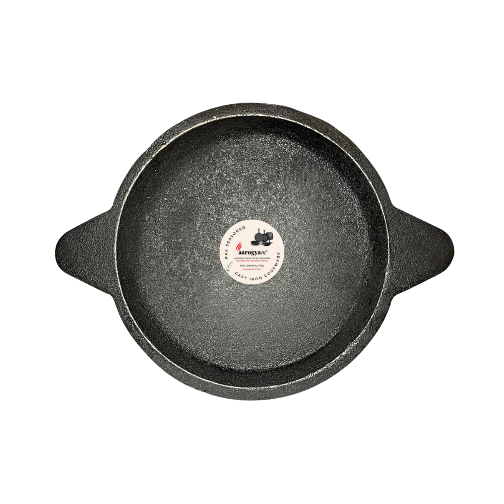 Black cast iron skillet with a brand label on a white background
