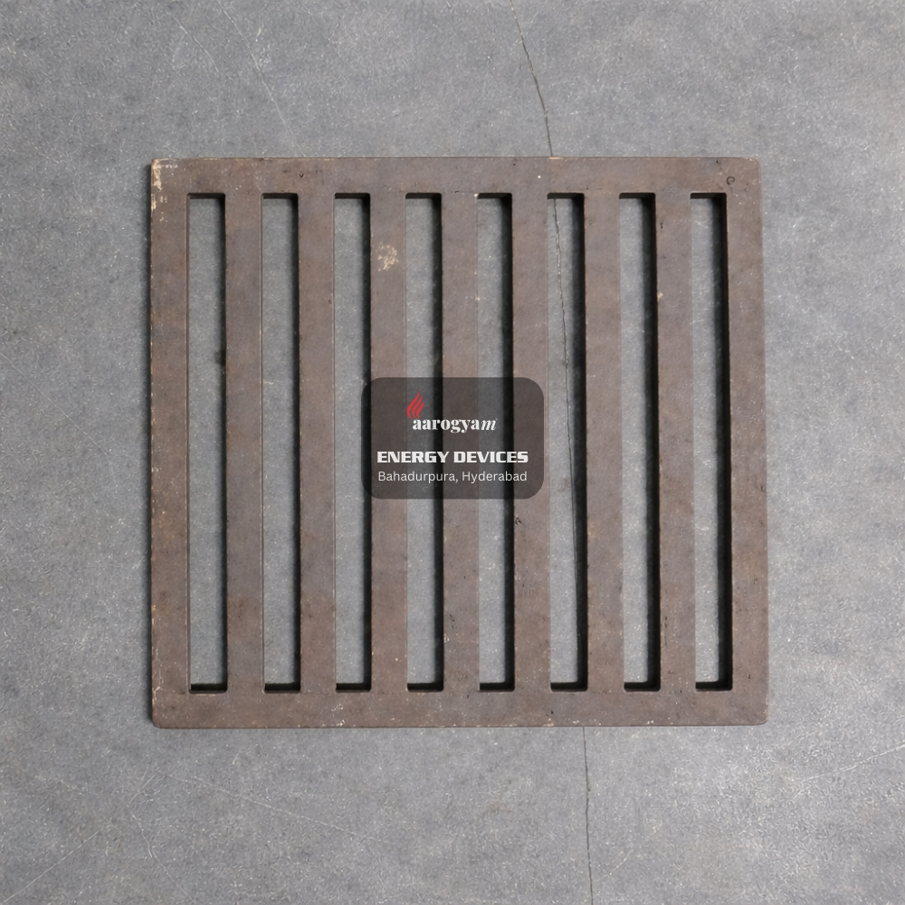 Metal drain cover with 'aarogyam ENERGY DEVICES' label on a gray concrete floor