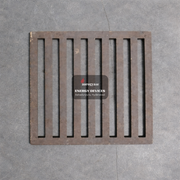 Metal drain cover with 'aarogyam ENERGY DEVICES' label on a gray concrete floor