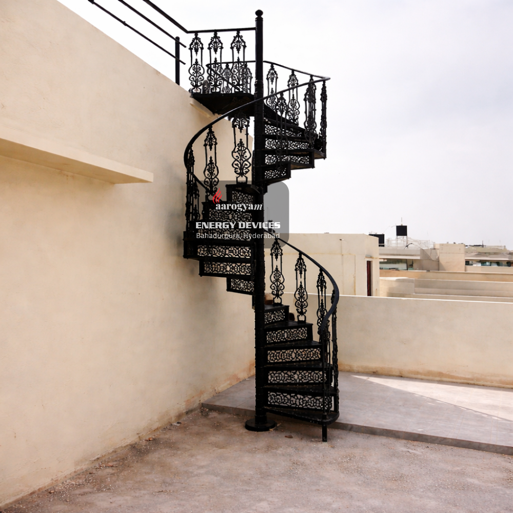 Black spiral staircase with decorative balusters in an indoor setting.
