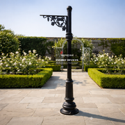 Black decorative lamp post in a garden setting with 'Arogyam Energy Devices' branding.
