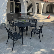 Black metal outdoor furniture set with a building in the background