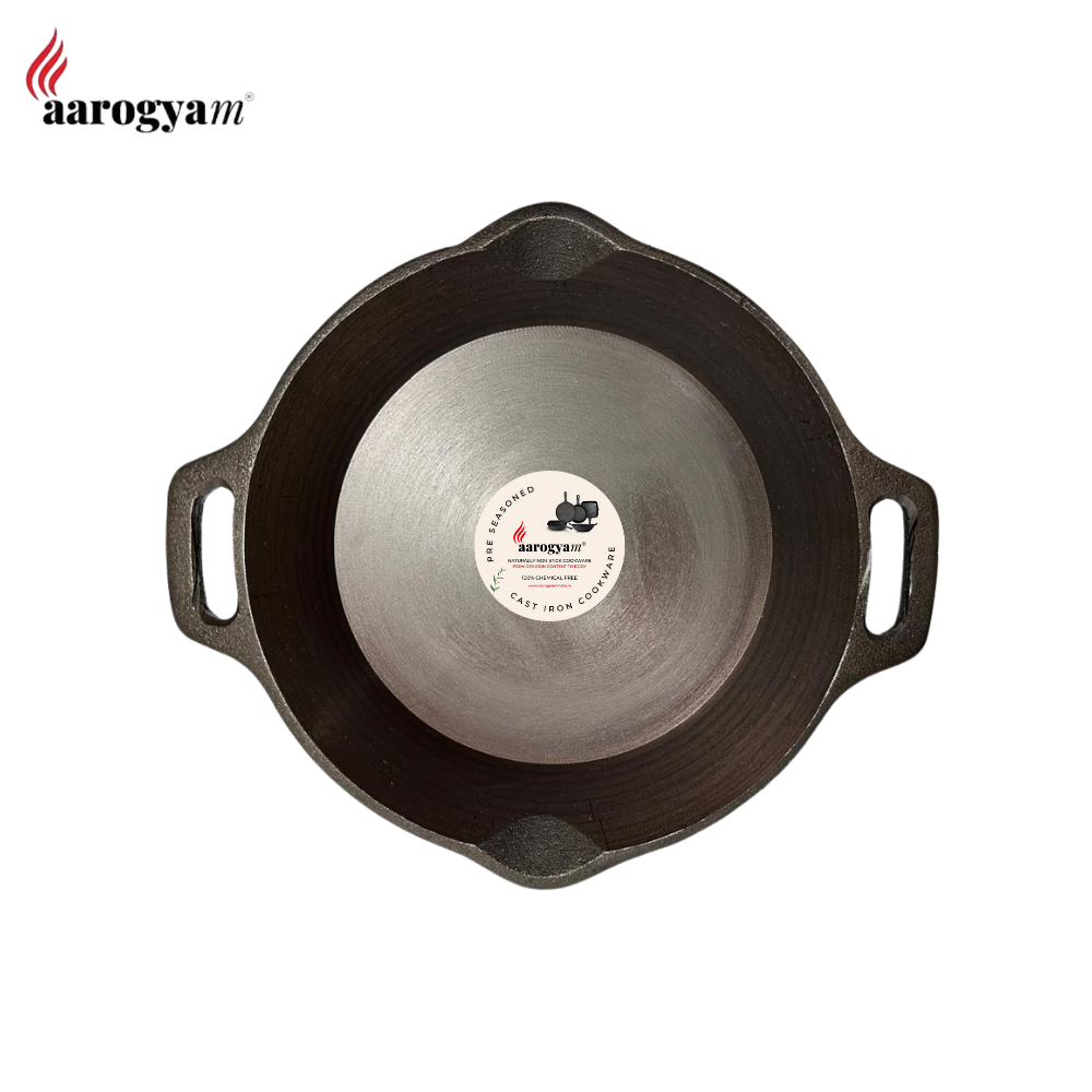 Cast iron skillet with a label on a white background, featuring the brand 'aarogya'.