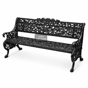 Decorative black metal bench with intricate designs on a white background