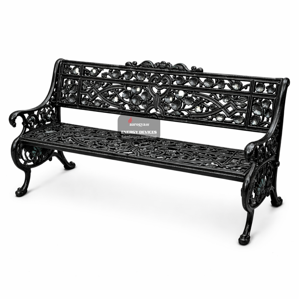 Decorative black metal bench with intricate designs on a white background