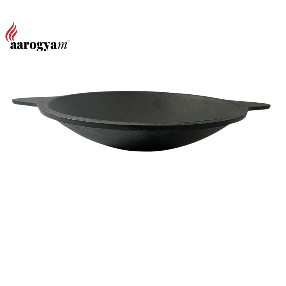 Black wok with 'aarogya' branding on a white background