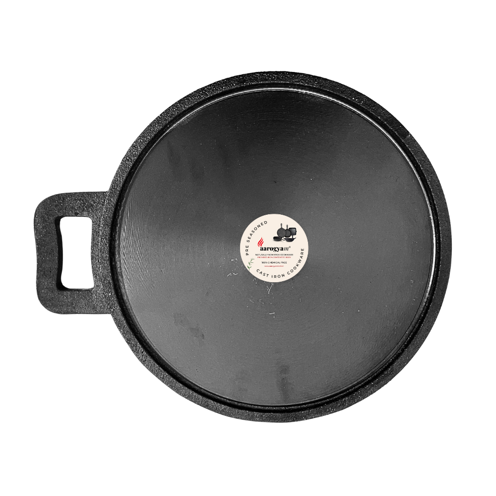 Black cast iron skillet with a label on a white background