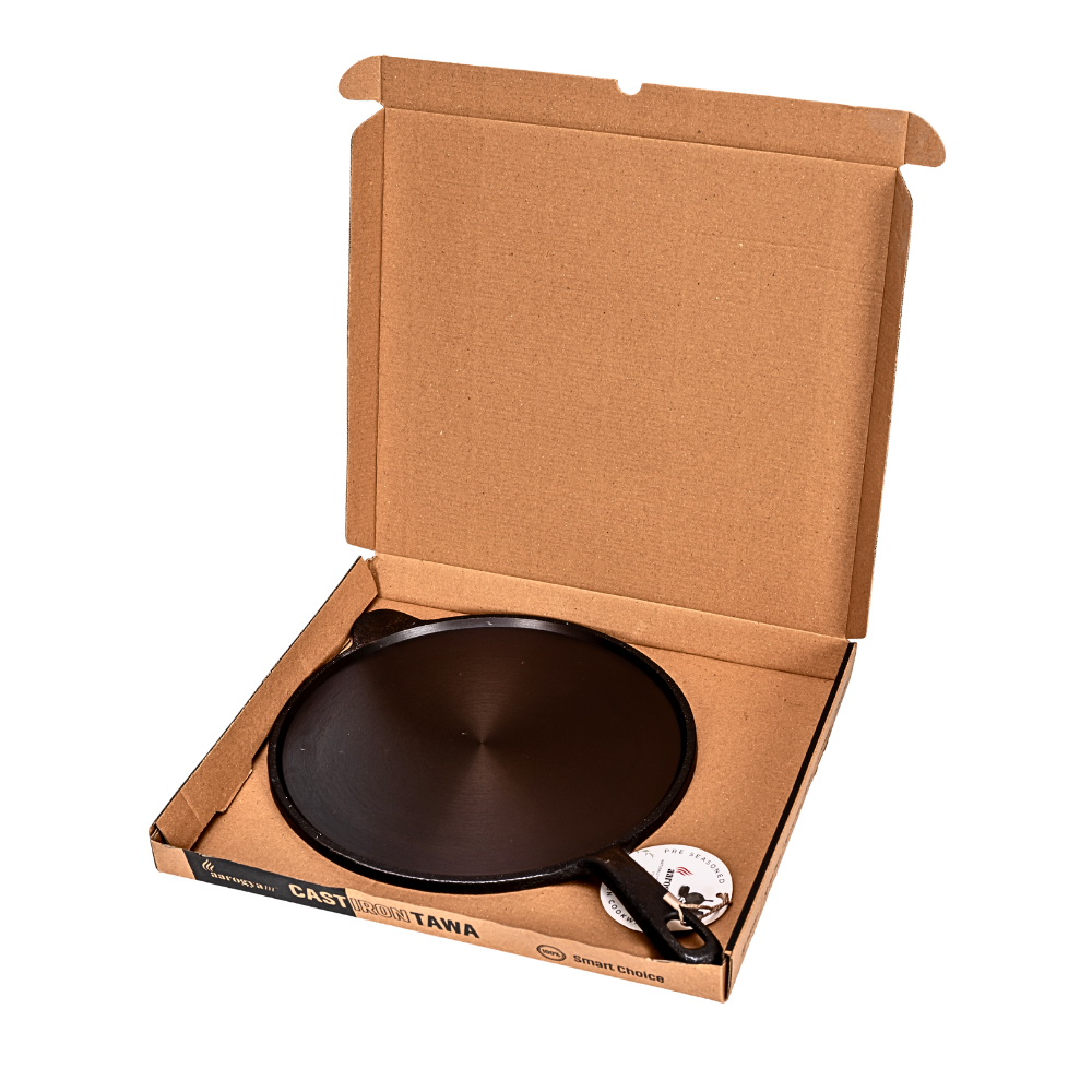 Cast iron tawa in a cardboard box on a white background