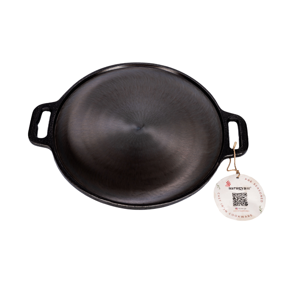 Black cast iron skillet with a brand tag on a white background