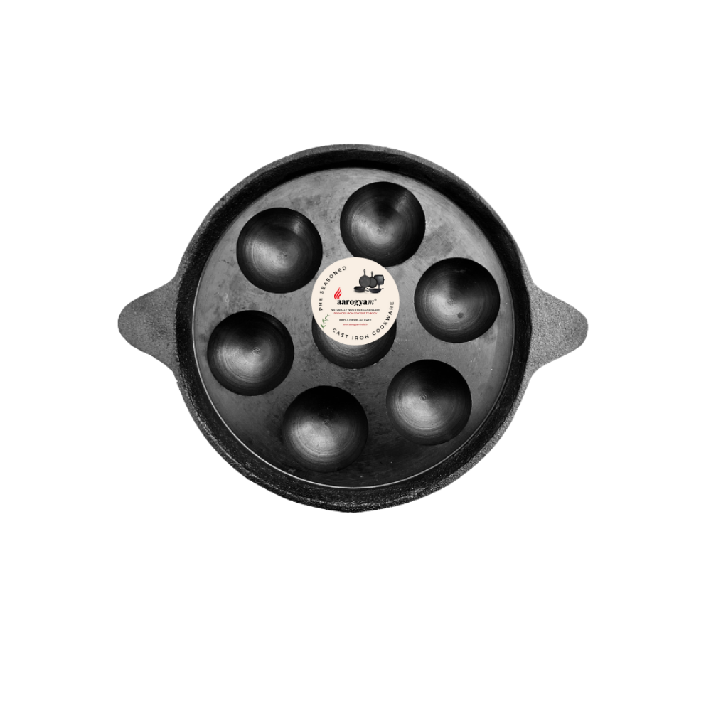 Black cast iron 7-hole mold on a white background