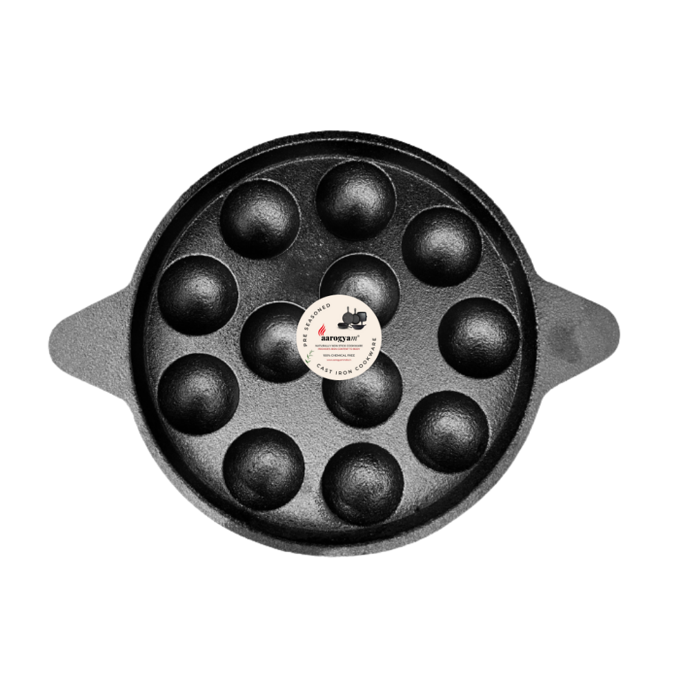 Black round baking pan with spherical compartments on a white background