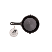 Cast iron skillet with a handle on a white background, featuring a brand tag.