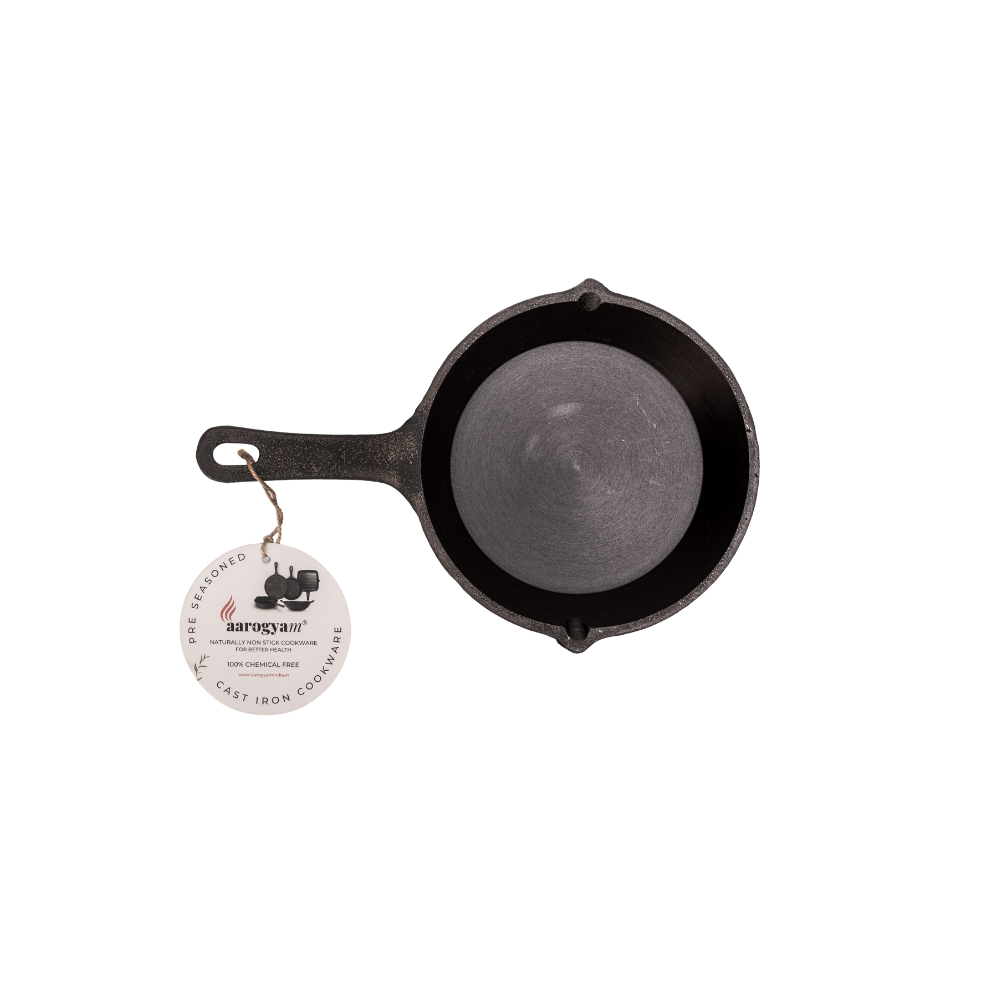 Cast iron skillet with a handle on a white background, featuring a brand tag.