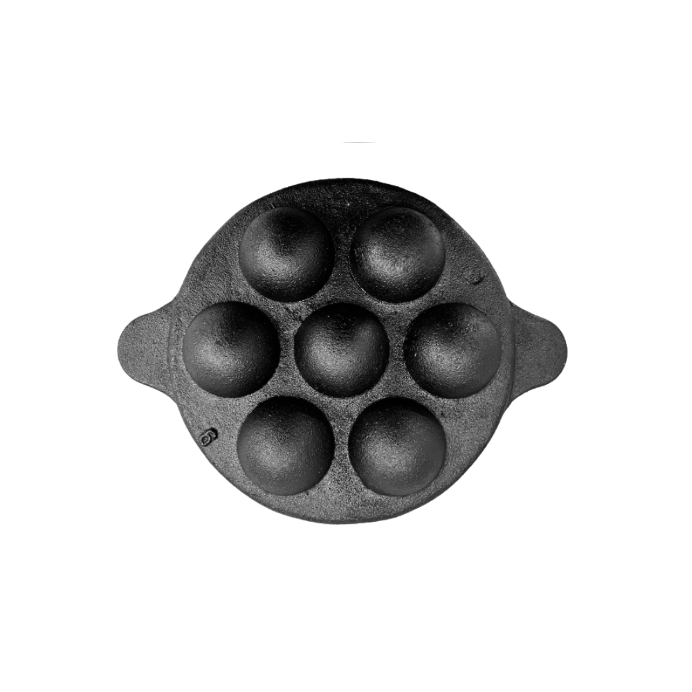 Black cast iron mold with six round cavities on a white background