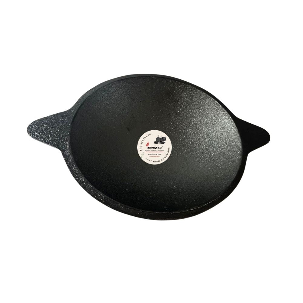 Black cast iron skillet with a brand label on a white background