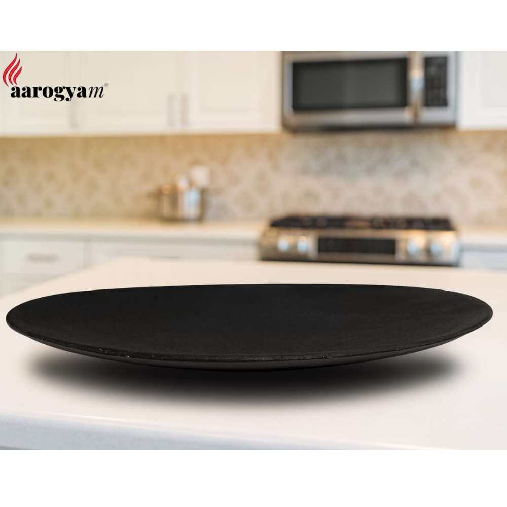 Black plate on a kitchen counter with 'aarogya' branding.