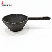 Black cast iron ladle on a white background with 'aarogyam' branding.