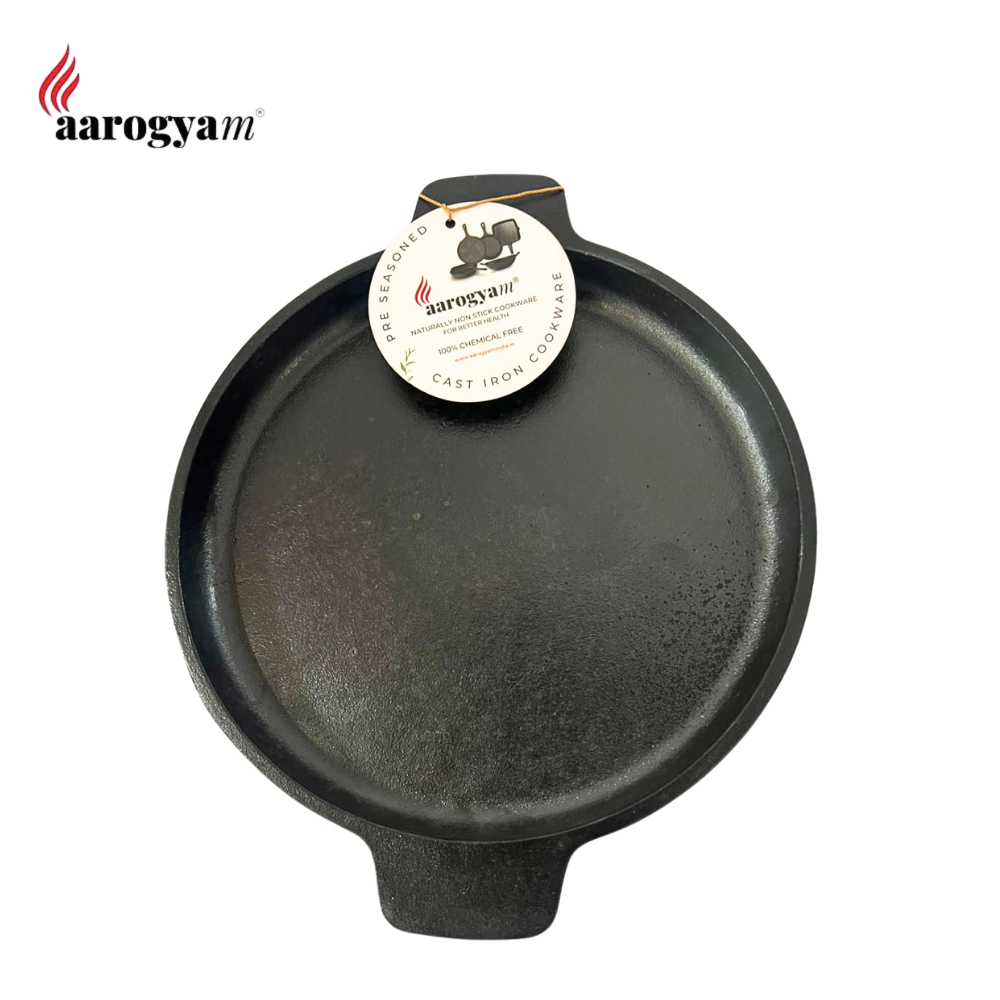 Black cast iron skillet with aarogyam label on a white background