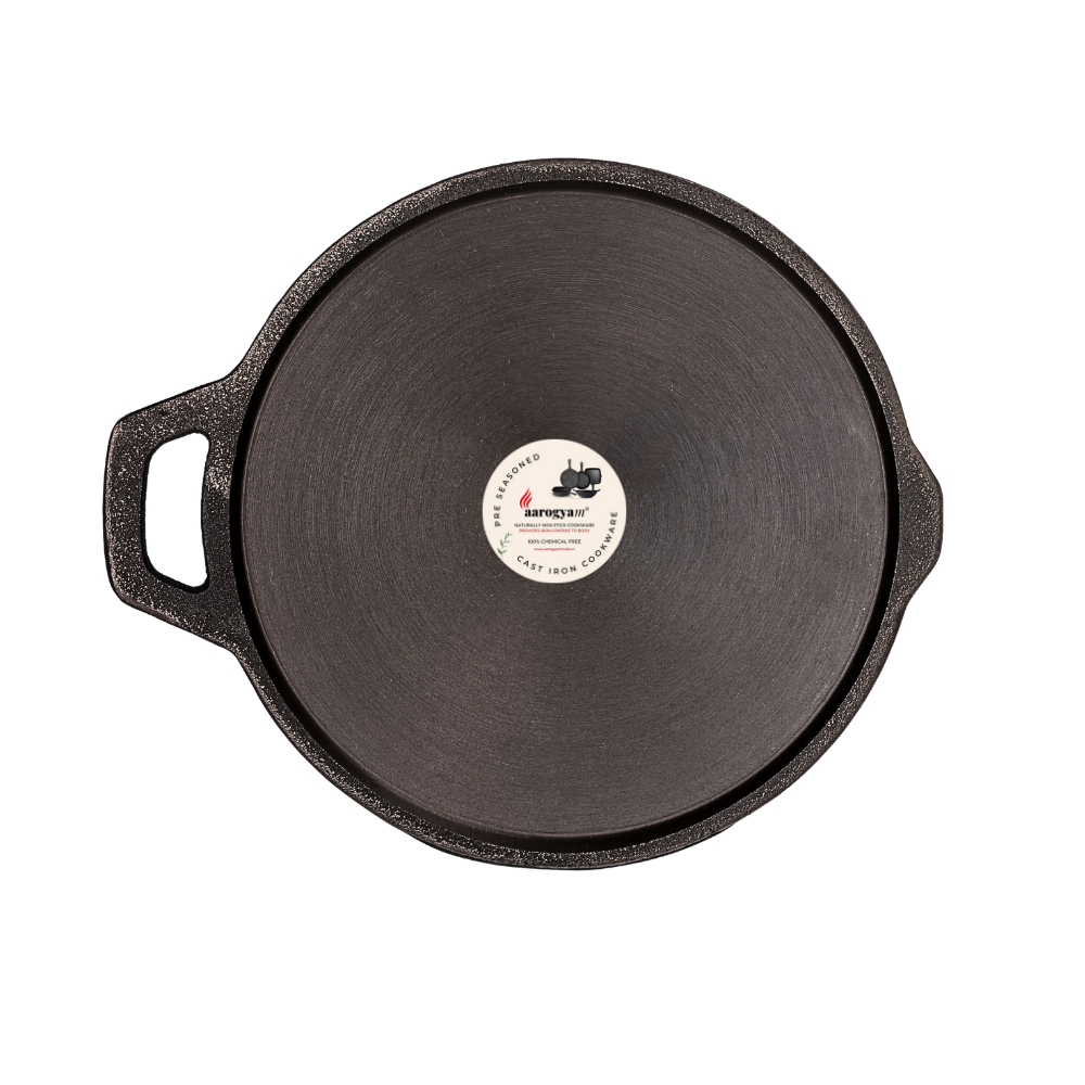 Black cast iron skillet with a brand label on a white background