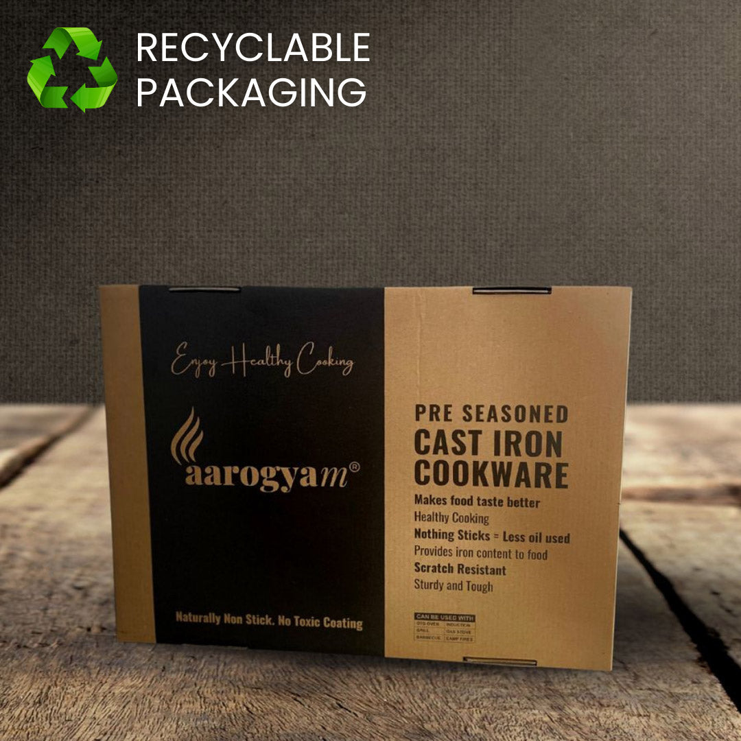 Aarogym pre-seasoned cast iron cookware packaging with recyclable label on a wooden surface.