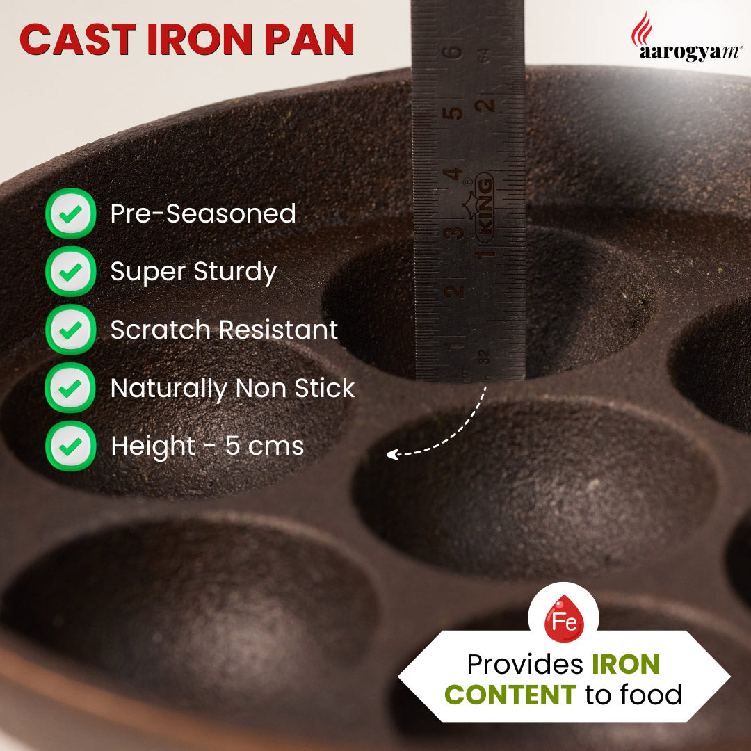 Cast iron pan with measurement of height and listed features, branded 'Aarogya'.