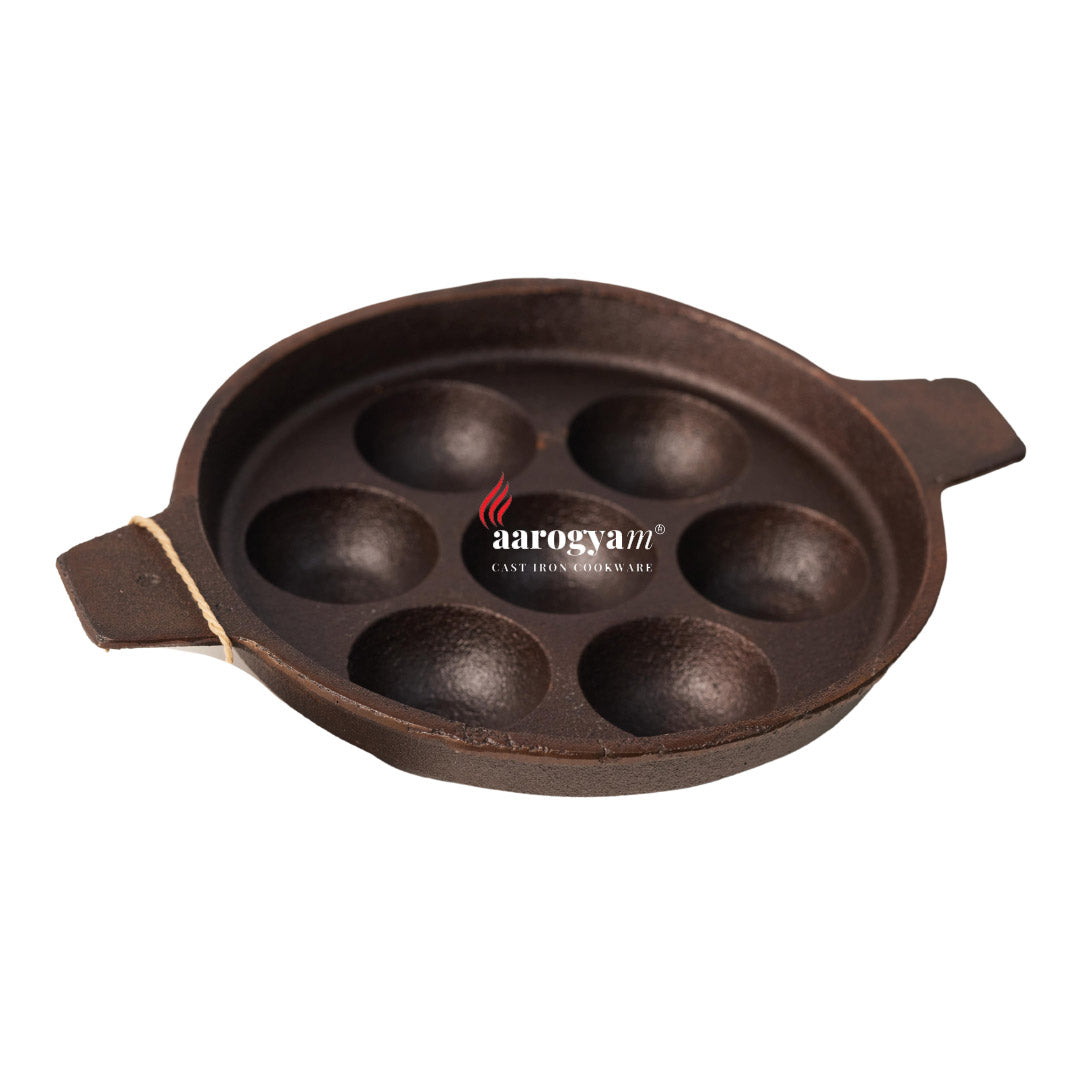 Cast iron pan with handles on a white background, featuring the Aarogyan brand.