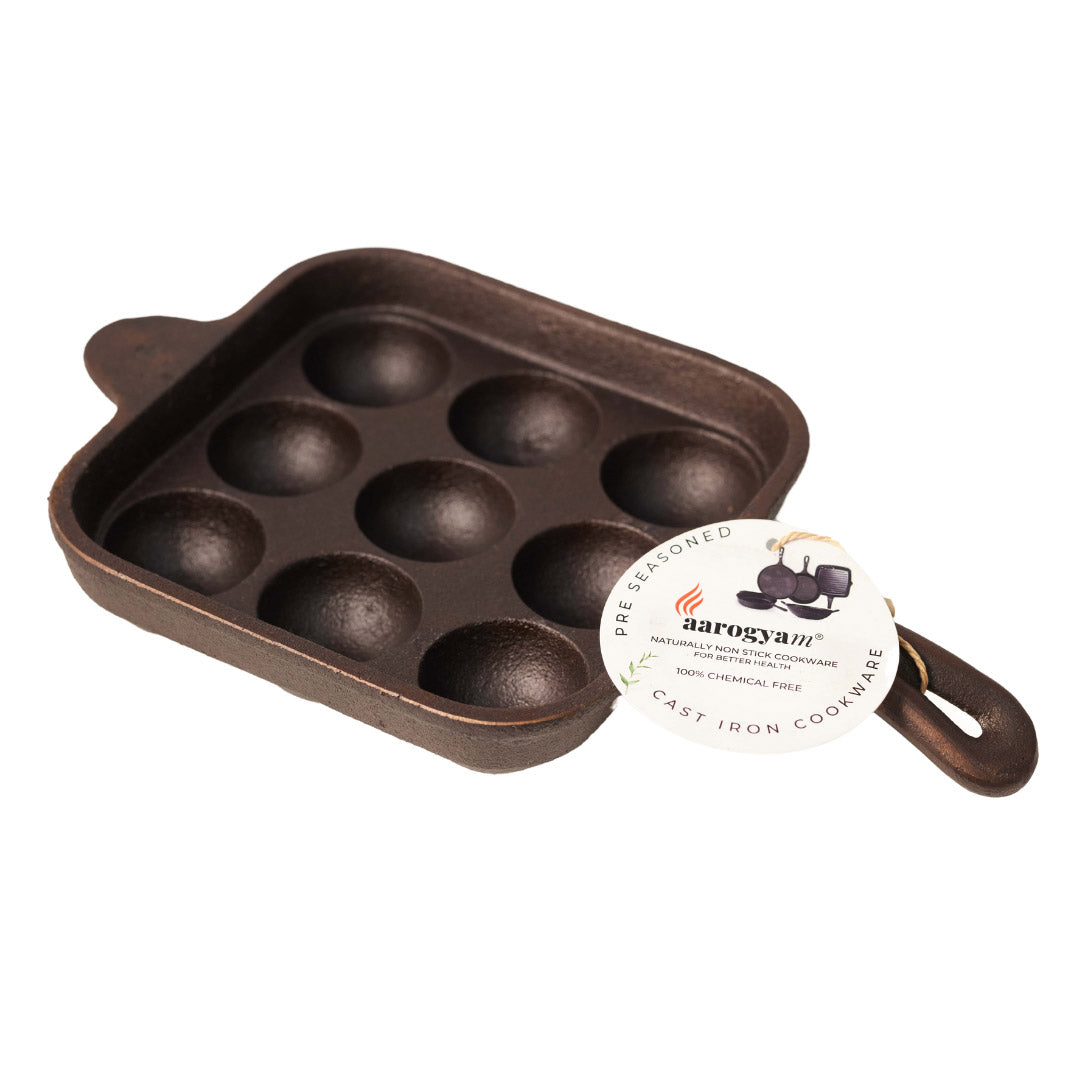 Cast iron muffin pan with a Daroczy brand label on a white background