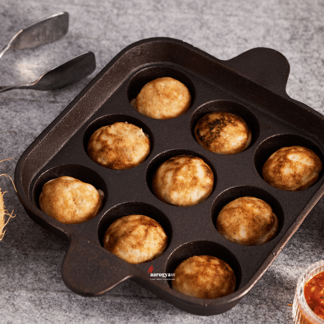 Muffin tin with baked muffins on a gray surface