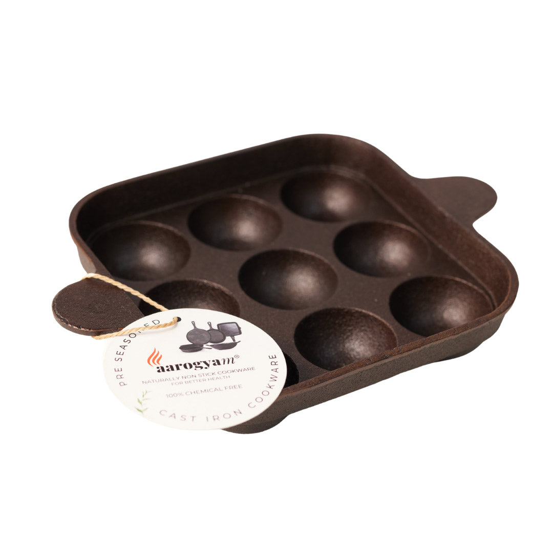 Brown cast iron mold with aarogyan label on a white background