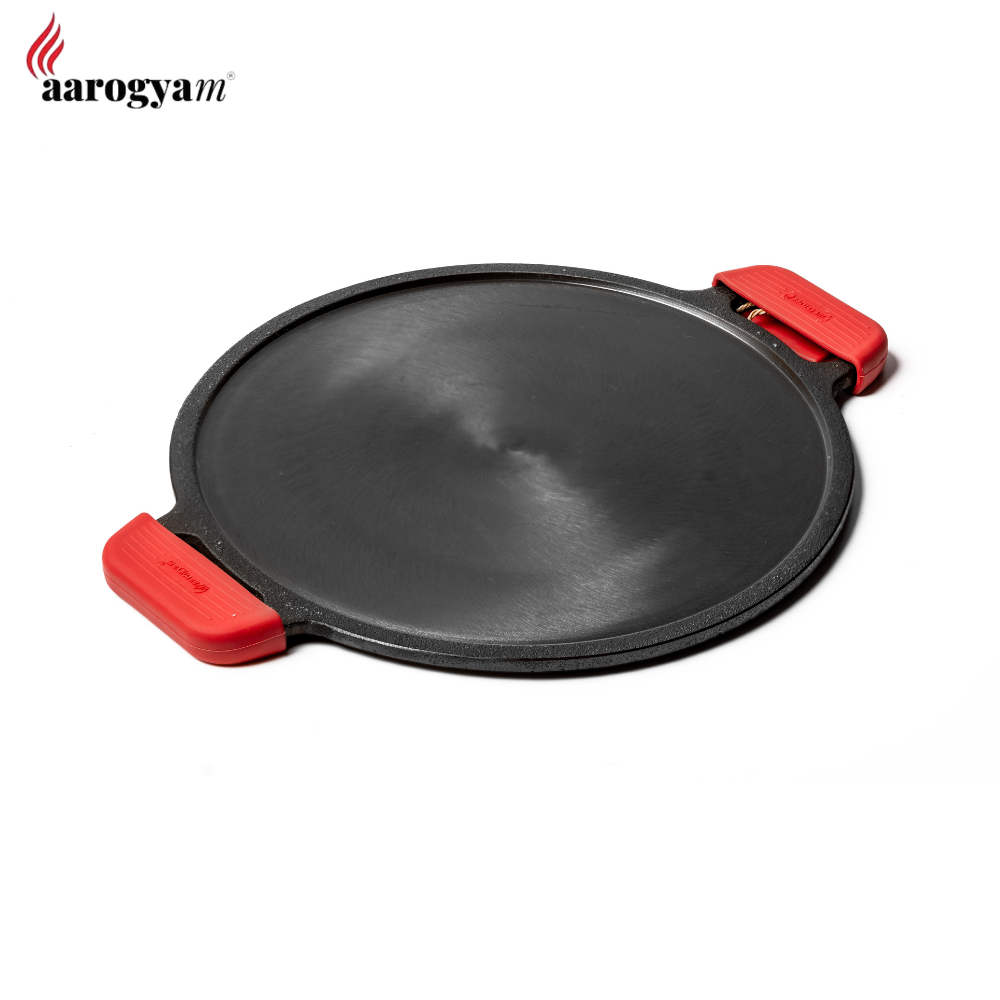 Black round cooking pan with red handles on a white background, featuring the Aarogyam brand.