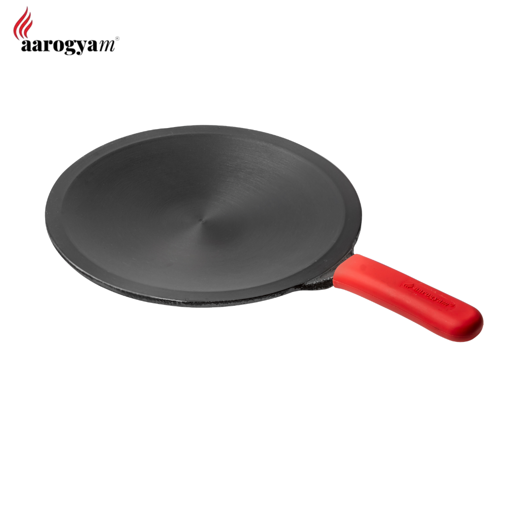 Black frying pan with a red handle on a white background, featuring the Aarogya brand.