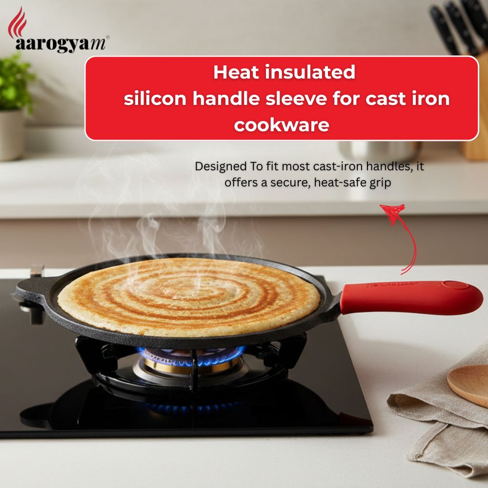 Cooking pan with a heat-insulated silicon handle sleeve on a stove, featuring the Aarogyam brand.