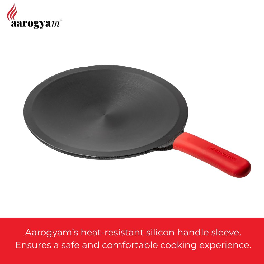 Black frying pan with a red handle on a white background, featuring Aarogya brand.