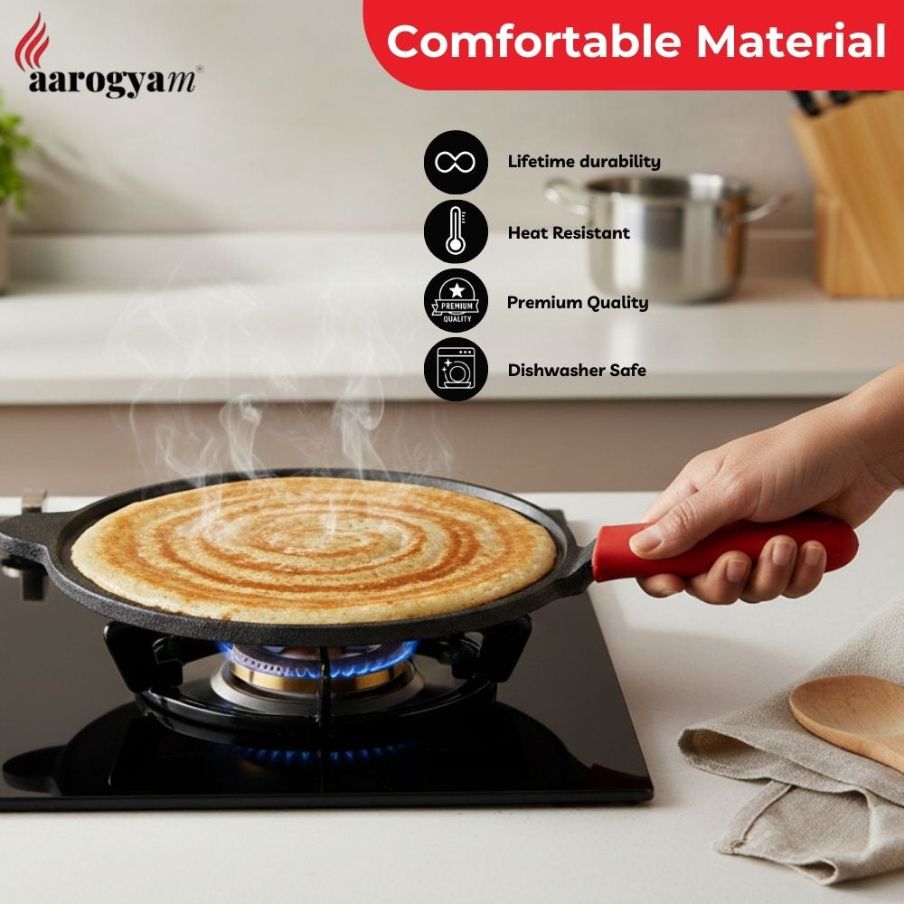 Person holding a frying pan with a cooked dish on a stove, featuring the aarogyam brand.